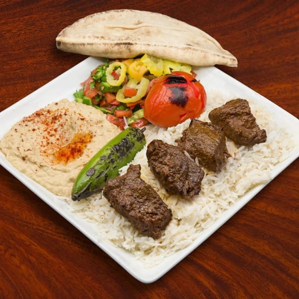 Sepan Chicken's Mediterranean plate with beef kebab, rice, hummus, salad, grilled tomato, pepper, and pita.